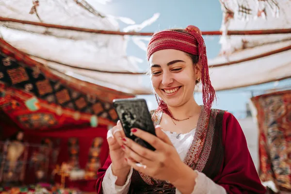 9777BEF Mobile Casino — Play anytime, anywhere A player using their smartphone during a festive local event, representing 9777BEF’s fully mobile-friendly casino.